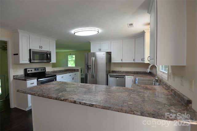 280 Fletcher View Dr, Fletcher, NC 28732 - kitchen featuring stainless steel appliances, a sink, a peninsula, white cabinets, and dark wood-type flooring