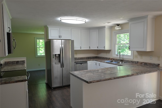 280 Fletcher View Dr, Fletcher, NC 28732 - kitchen with appliances with stainless steel finishes, a sink, a peninsula, dark wood finished floors, and white cabinetry