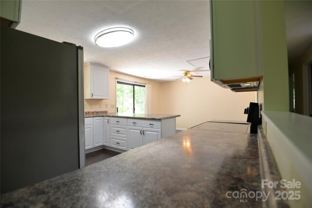 280 Fletcher View Dr, Fletcher, NC 28732 - kitchen with freestanding refrigerator, white cabinets, ceiling fan, a peninsula, and dark wood-style flooring