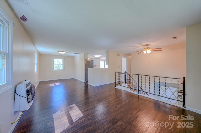 280 Fletcher View Dr, Fletcher, NC 28732 - unfurnished living room with wood finished floors, baseboards, a wall mounted AC, and a ceiling fan