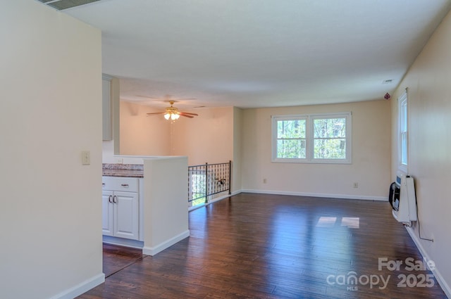 280 Fletcher View Dr, Fletcher, NC 28732 - unfurnished living room with heating unit, dark wood finished floors, baseboards, and ceiling fan