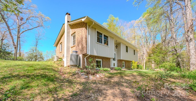 280 Fletcher View Dr, Fletcher, NC 28732 - view of property exterior with brick siding, a chimney, a lawn, and central AC