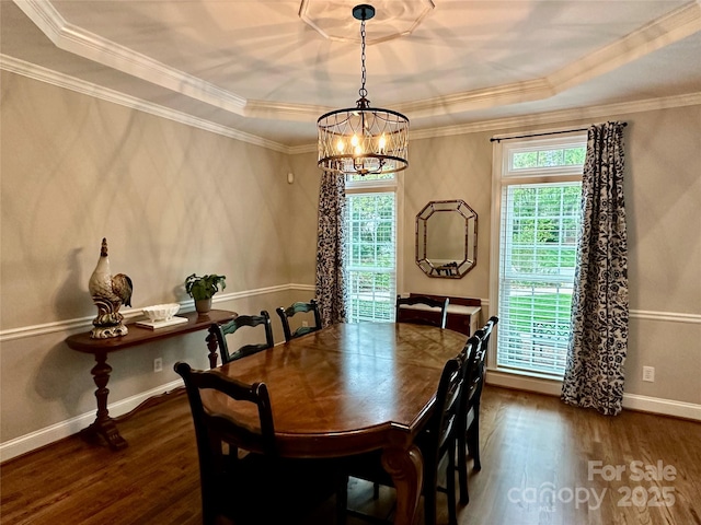 9508 Hayenridge Ct, Huntersville, NC 28078 - dining area with baseboards, a raised ceiling, an inviting chandelier, ornamental molding, and wood finished floors