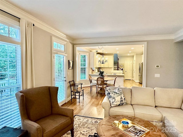 9508 Hayenridge Ct, Huntersville, NC 28078 - living area featuring crown molding, baseboards, light wood finished floors, and an inviting chandelier