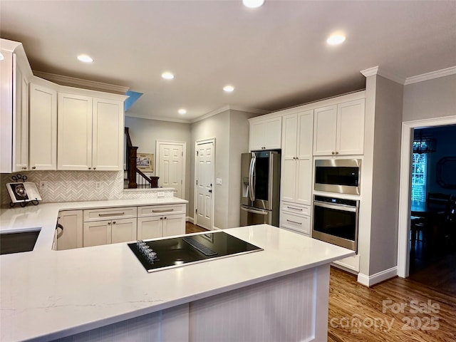 9508 Hayenridge Ct, Huntersville, NC 28078 - kitchen with a peninsula, white cabinetry, appliances with stainless steel finishes, wood finished floors, and decorative backsplash