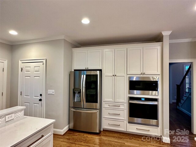 9508 Hayenridge Ct, Huntersville, NC 28078 - kitchen featuring ornamental molding, white cabinetry, recessed lighting, wood finished floors, and stainless steel appliances