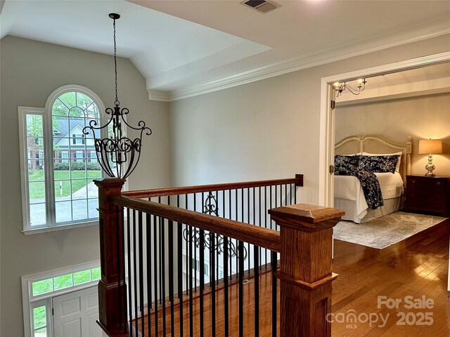 9508 Hayenridge Ct, Huntersville, NC 28078 - hall with crown molding, a chandelier, wood finished floors, lofted ceiling, and an upstairs landing