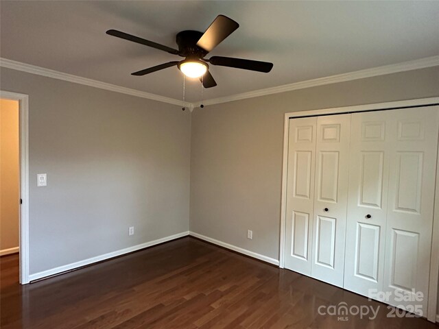 9508 Hayenridge Ct, Huntersville, NC 28078 - unfurnished bedroom with a closet, baseboards, dark wood-style flooring, ornamental molding, and a ceiling fan
