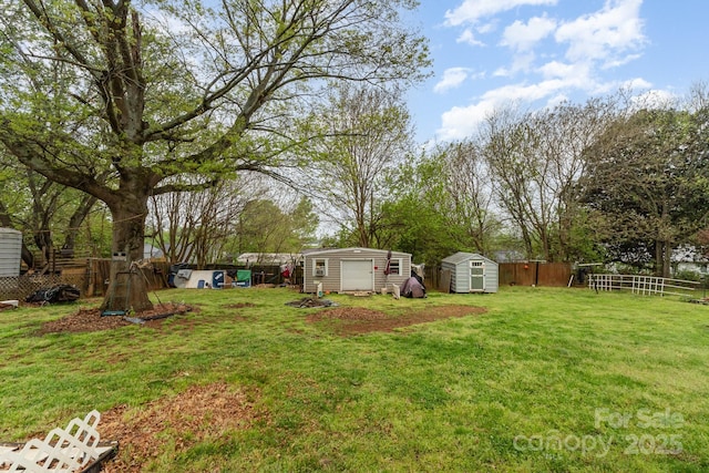 view of yard featuring a storage unit, a fenced backyard, and an outdoor structure