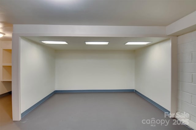 1473 12th Street Dr NW, Hickory, NC 28601 - empty room with concrete block wall and concrete flooring