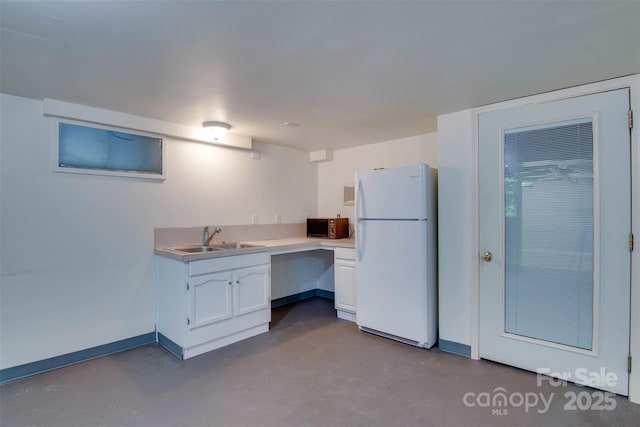 1473 12th Street Dr NW, Hickory, NC 28601 - kitchen with a sink, freestanding refrigerator, white cabinetry, and finished concrete floors