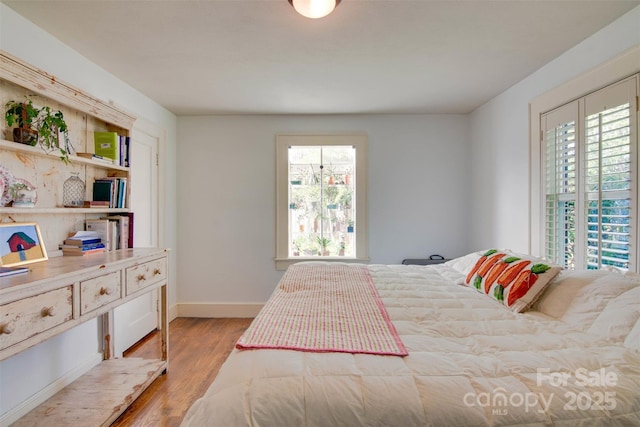 1473 12th Street Dr NW, Hickory, NC 28601 - bedroom featuring baseboards, multiple windows, and wood finished floors