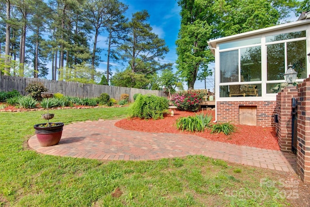 1473 12th Street Dr NW, Hickory, NC 28601 - view of yard with a fenced backyard, a patio area, and a sunroom