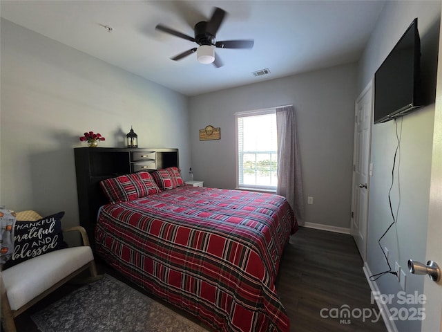 bedroom featuring visible vents, baseboards, a ceiling fan, and wood finished floors