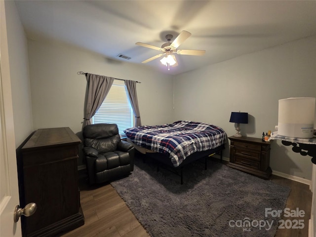bedroom featuring visible vents, a ceiling fan, and wood finished floors