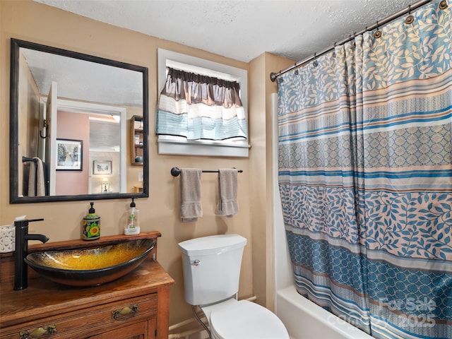 full bath with shower / bath combination with curtain, toilet, vanity, and a textured ceiling