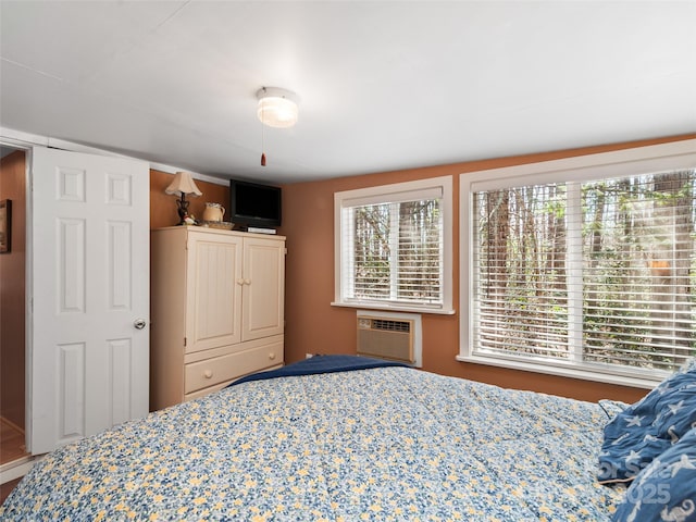 bedroom with an AC wall unit