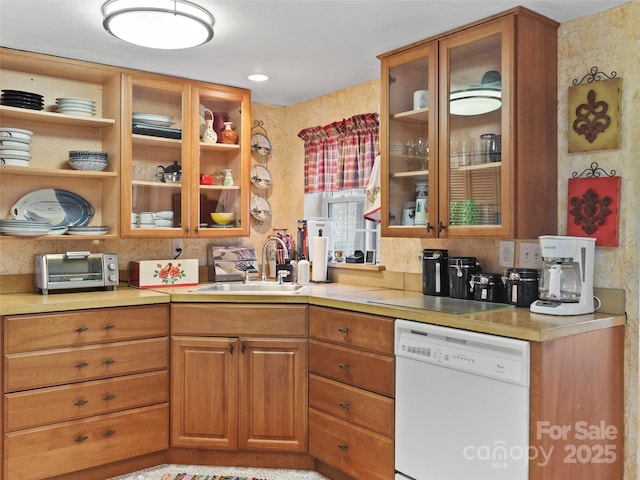 kitchen featuring a toaster, glass insert cabinets, light countertops, dishwasher, and a sink