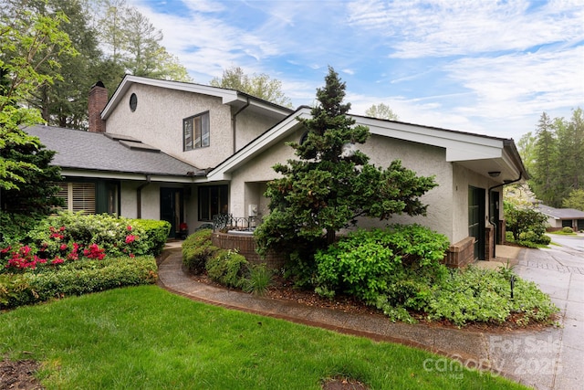 11 Bourne Ln, Asheville, NC 28803 - view of front of home featuring stucco siding, a chimney, and driveway