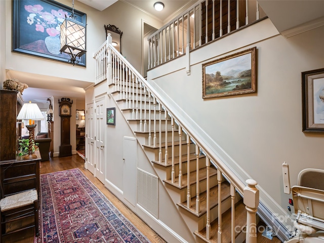 11 Bourne Ln, Asheville, NC 28803 - stairway featuring wood finished floors, a chandelier, ornamental molding, visible vents, and a high ceiling