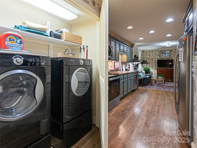 11 Bourne Ln, Asheville, NC 28803 - washroom with a sink, washing machine and dryer, recessed lighting, wood finished floors, and laundry area
