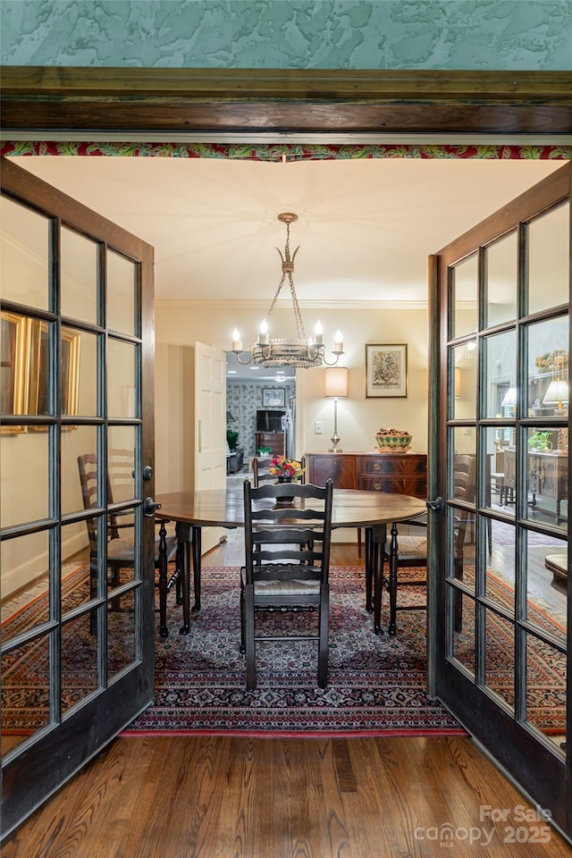 11 Bourne Ln, Asheville, NC 28803 - dining space featuring crown molding, an inviting chandelier, french doors, and dark wood-type flooring
