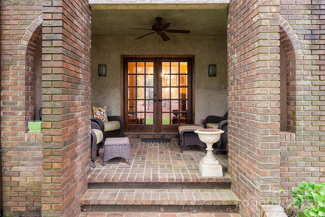 11 Bourne Ln, Asheville, NC 28803 - view of exterior entry with stucco siding, ceiling fan, french doors, and brick siding