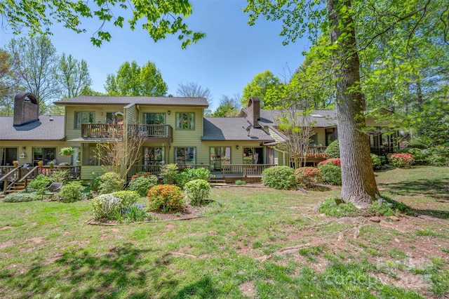 8 Hunting Country Trl, Tryon, NC 28782 - rear view of house featuring a chimney, a balcony, a deck, and a lawn