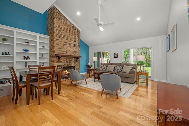 8 Hunting Country Trl, Tryon, NC 28782 - living room with high vaulted ceiling, light wood-style floors, a brick fireplace, and ceiling fan