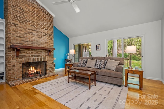 8 Hunting Country Trl, Tryon, NC 28782 - living area featuring a brick fireplace, a ceiling fan, high vaulted ceiling, and wood finished floors
