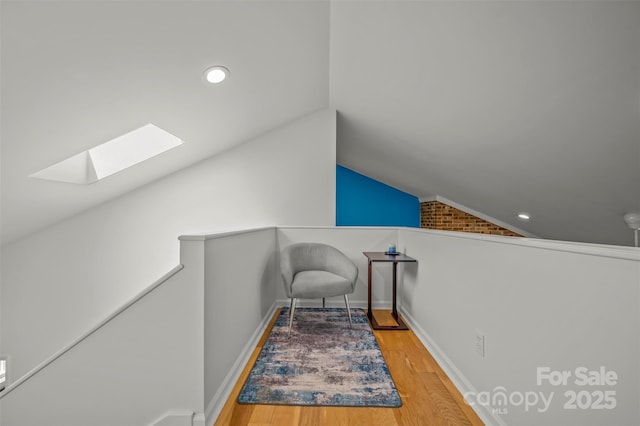 8 Hunting Country Trl, Tryon, NC 28782 - sitting room with vaulted ceiling with skylight, recessed lighting, wood finished floors, an upstairs landing, and baseboards