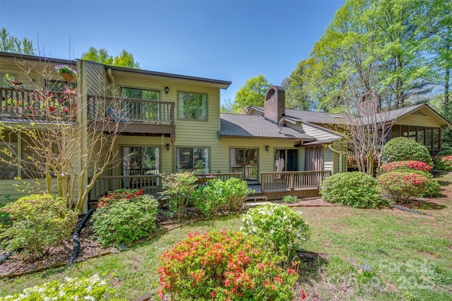8 Hunting Country Trl, Tryon, NC 28782 - back of house with a balcony, a chimney, and a lawn