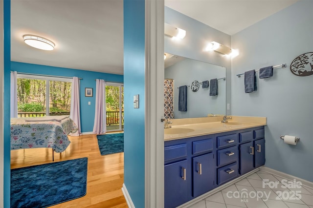 8 Hunting Country Trl, Tryon, NC 28782 - full bath featuring a sink, baseboards, double vanity, and wood finished floors