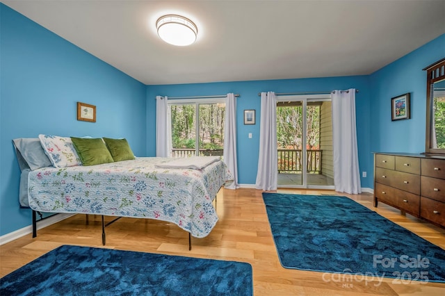 8 Hunting Country Trl, Tryon, NC 28782 - bedroom featuring access to outside, wood finished floors, and baseboards
