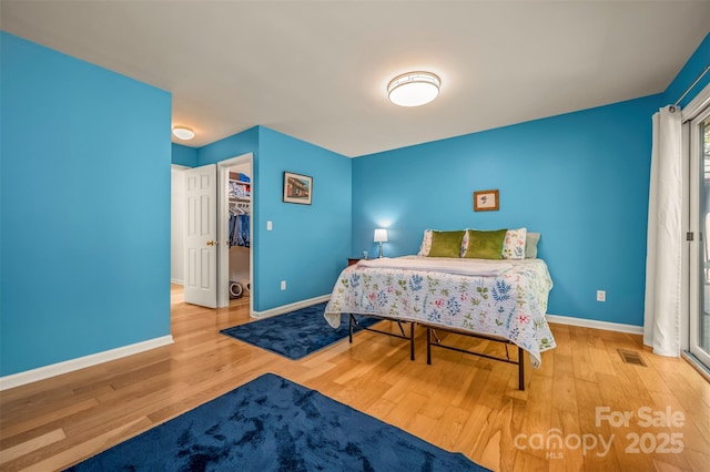 8 Hunting Country Trl, Tryon, NC 28782 - bedroom with wood finished floors, baseboards, a spacious closet, and visible vents