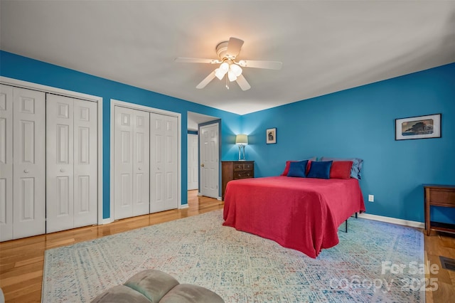 8 Hunting Country Trl, Tryon, NC 28782 - bedroom featuring baseboards, two closets, a ceiling fan, and wood finished floors