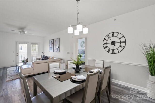 dining room featuring wood finished floors, ceiling fan, and baseboards
