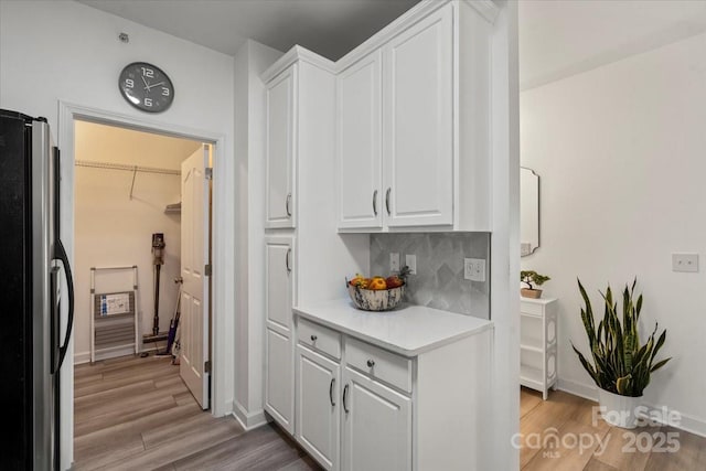 interior space featuring light wood-type flooring and baseboards
