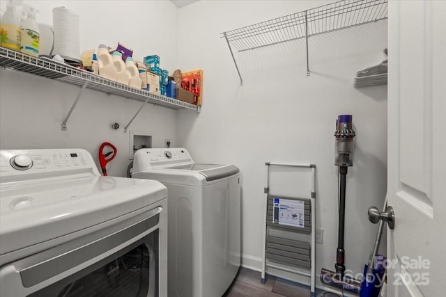 laundry area with washer and dryer, laundry area, dark wood-style flooring, and baseboards