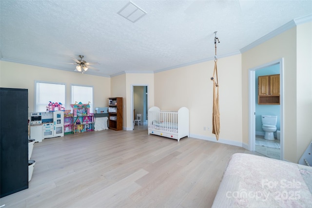 bedroom with crown molding, a textured ceiling, visible vents, and light wood-style flooring