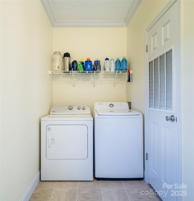 laundry area with crown molding, washer and clothes dryer, laundry area, and a textured ceiling