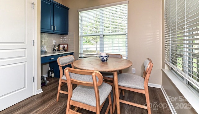 dining area featuring dark wood-style floors and baseboards