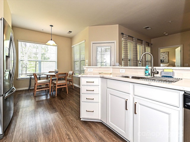 kitchen featuring light countertops, dark wood-style flooring, white cabinetry, visible vents, and stainless steel refrigerator with ice dispenser