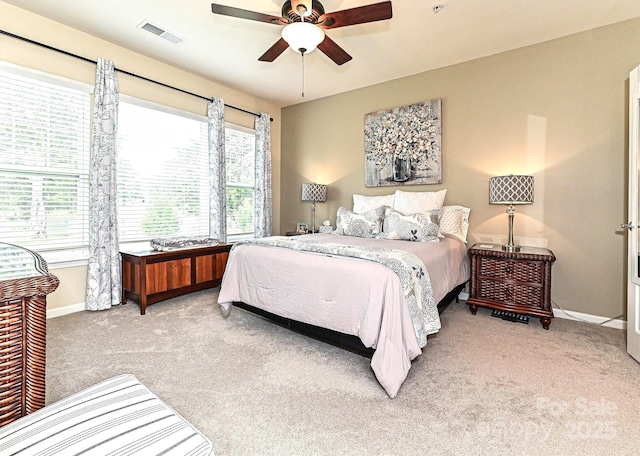 carpeted bedroom featuring visible vents, ceiling fan, and baseboards