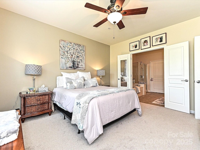 bedroom featuring connected bathroom, ceiling fan, and carpet floors