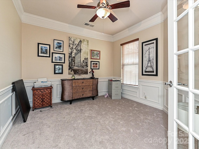 interior space featuring ornamental molding, visible vents, wainscoting, and a decorative wall
