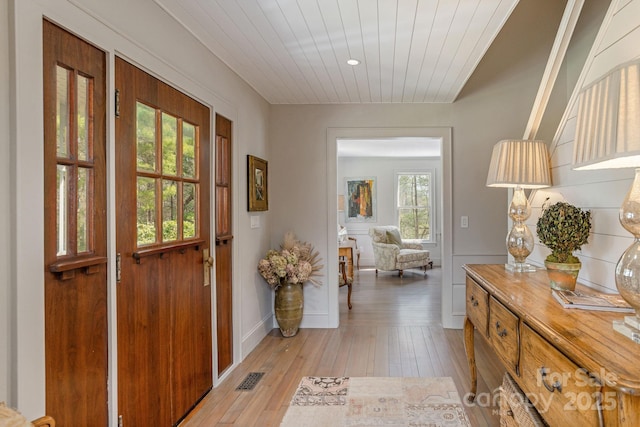 doorway featuring wooden ceiling, light wood finished floors, and visible vents