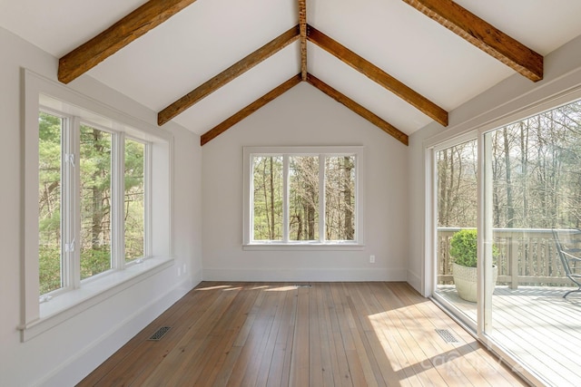 unfurnished sunroom with beam ceiling and visible vents