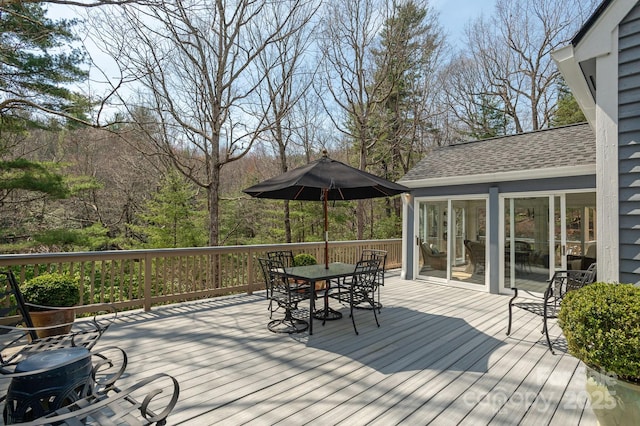 wooden terrace with outdoor dining area