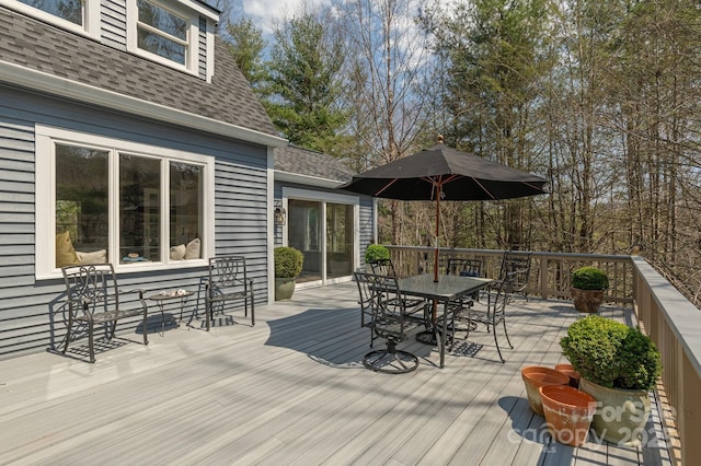 wooden deck featuring outdoor dining area
